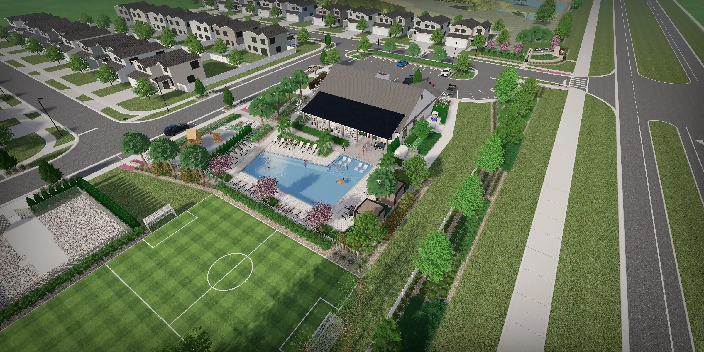 Aerial view of luxury residential community featuring resort-style pool, cabana pavilion, soccer field, and multi-family homes surrounding manicured landscaping in St Petersburg, FL.