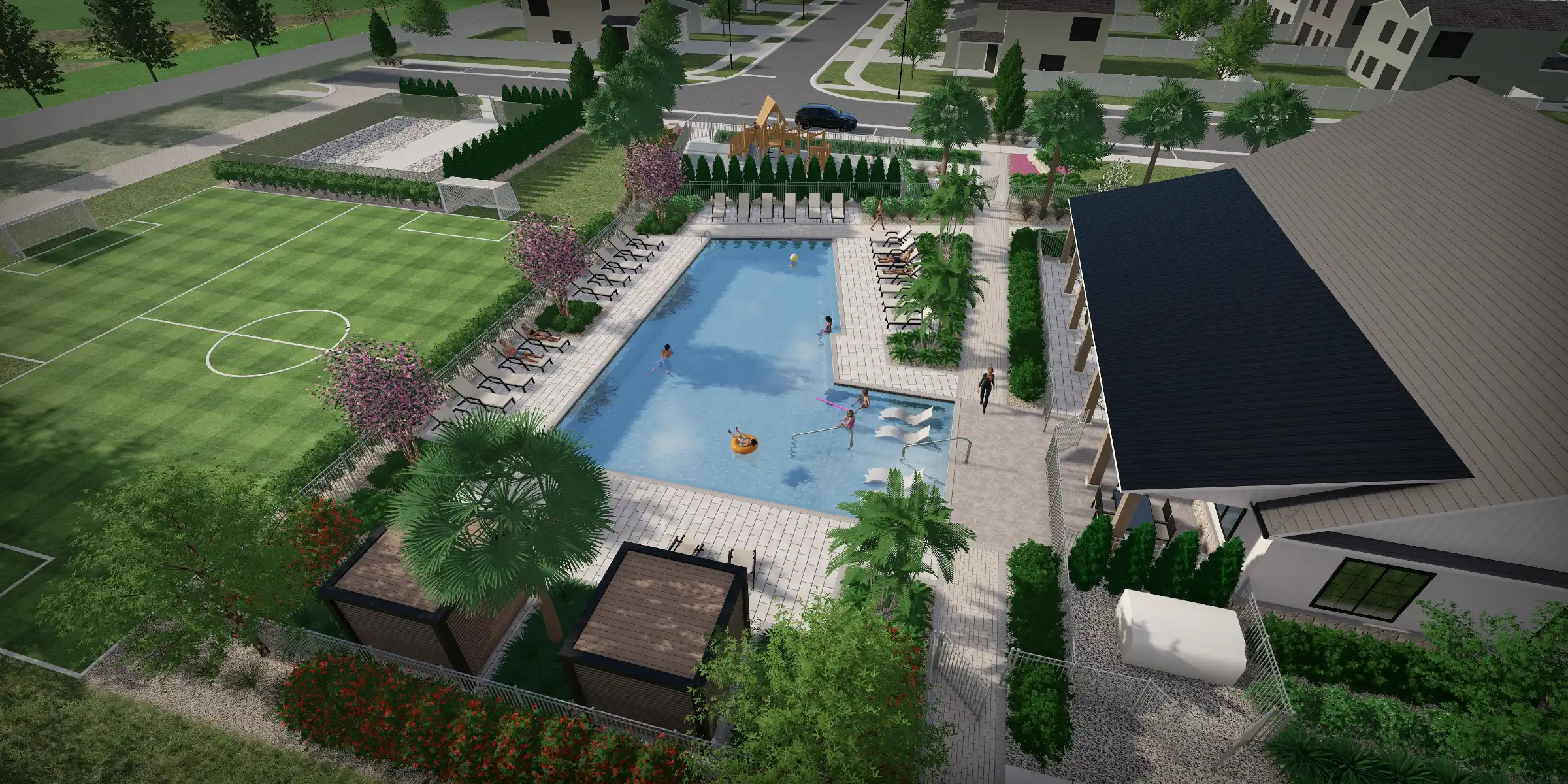 Aerial view of resort-style pool complex with loungers, shallow children's area, and manicured landscape design in residential community setting.